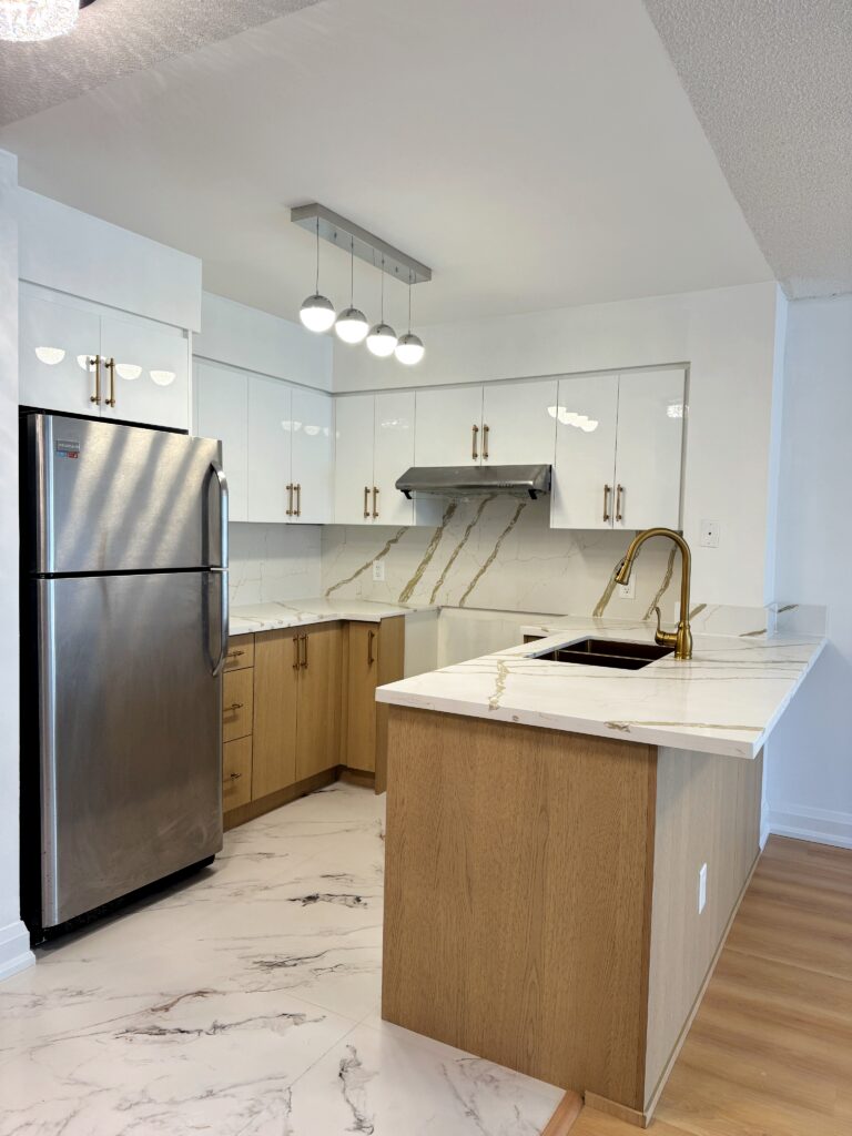 Scarborough kitchen renovation featuring a custom-built island with deep drawers and quartz surfaces.